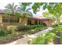 Attractive brick home with lush landscaping and a welcoming walkway to the front door at 429 Kimberly Ct, Sanford, FL 32771
