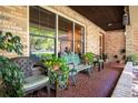 Cozy front porch with seating, potted plants, and a brick facade at 429 Kimberly Ct, Sanford, FL 32771