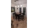 Dining area with a square table and four chairs near white french doors, bathed in natural light at 4920 E Lake Cove Blvd, St Cloud, FL 34771