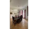 Charming dining room features dark wood table and chairs, as well as striped window treatments at 4920 E Lake Cove Blvd, St Cloud, FL 34771