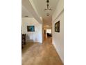 Bright foyer features neutral paint, tiled floors, and stylish chandelier at 4920 E Lake Cove Blvd, St Cloud, FL 34771