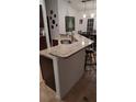 Kitchen island featuring a granite countertop, stainless steel sink, and breakfast bar seating at 4920 E Lake Cove Blvd, St Cloud, FL 34771