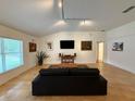 Spacious living room with neutral tile flooring, natural lighting, and ample space for entertaining at 4920 E Lake Cove Blvd, St Cloud, FL 34771