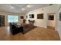 Bright living room with vaulted ceilings, tile floors, modern track lighting, and neutral wall colors at 4920 E Lake Cove Blvd, St Cloud, FL 34771