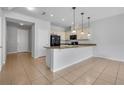 Kitchen featuring sleek black appliances, pendant lights, and ample counter space at 5118 Adelaide Dr, Kissimmee, FL 34746