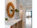 Inviting entryway showcasing stylish console table and decorative mirror, creating a warm ambiance at 5133 Masser Rd, St Cloud, FL 34772
