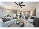 Open-concept living room is bright and airy, featuring stylish furnishings and decor at 540 Southern Edge Way, Sanford, FL 32771