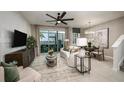 Relaxing living room featuring modern décor and a sliding glass door to the lanai at 540 Southern Edge Way, Sanford, FL 32771
