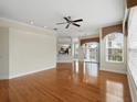 Inviting living room with hardwood floors, a ceiling fan, recessed lighting, and a view to the kitchen at 7021 Della Dr # 51, Orlando, FL 32819