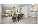Bright dining area with modern gray flooring leading into a living area and kitchen at 711 Swan Ln, Altamonte Springs, FL 32701