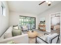 Comfortable living room features an inviting color scheme, fan, and access to a screened-in porch at 711 Swan Ln, Altamonte Springs, FL 32701