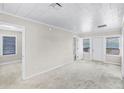 Bright living room featuring neutral walls, carpet floors, and plenty of natural light at 730 S Main Ave, Groveland, FL 34736