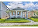 Attractive single-story home with a lush green lawn, inviting covered porch, and eye-catching stone accents at 744 Yukon Ln, Debary, FL 32713