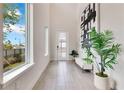 Bright foyer with soaring ceilings, modern art, and tiled floors at 7905 Jacks Club Dr, Kissimmee, FL 34747