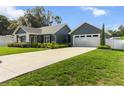 This single-Gathering home features an attached two-car garage, long driveway, and lawn at 8717 Se 156Th St, Summerfield, FL 34491