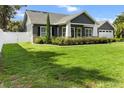 Well-manicured lawn and garden beds create a welcoming curb appeal for this lovely home at 8717 Se 156Th St, Summerfield, FL 34491