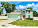 Inviting two-story home with a two-car garage, well-manicured lawn, and beautiful landscaping at 905 Cascade Falls Ln, Deland, FL 32720