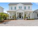 Charming home with a welcoming front porch, featuring rocking chairs and lush landscaping at 907 Celadon St, Winter Garden, FL 34787