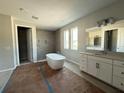 Bright bathroom featuring a soaking tub, walk-in shower, and double sink vanity at 960 Hawksnest Pt, Oviedo, FL 32765