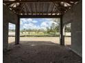 Covered outdoor living space under construction with an open view of the surrounding property at 960 Hawksnest Pt, Oviedo, FL 32765