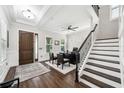 Beautiful home entryway showcasing hardwood floors, staircase, and an office area at 9574 Meadow Hunt Way, Winter Garden, FL 34787