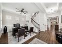 Elegant entryway with hardwood floors, staircase, and a glimpse of the dining room at 9574 Meadow Hunt Way, Winter Garden, FL 34787