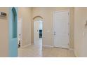 Bright and spacious foyer with tile flooring, arched doorways, and neutral paint at 1023 Hermosa Way, Kissimmee, FL 34744