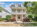 Inviting two-story home featuring a covered front porch and an upper-level balcony at 1131 Indigo Dr, Kissimmee, FL 34747