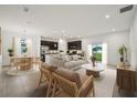 An open-concept living room features modern decor, a kitchen, and a dining room at 1247 Blue Daze Ln, Eustis, FL 32726