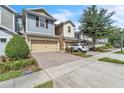 Well-maintained townhome with a brick paver driveway and a lush, green lawn at 1262 E 10Th St, Apopka, FL 32703