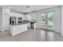 Stylish kitchen with white cabinets, a center island, and modern stainless steel appliances at 1262 E 10Th St, Apopka, FL 32703