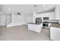 Open-concept kitchen with stainless steel appliances and a granite-topped island at 1262 E 10Th St, Apopka, FL 32703