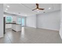 Open-concept living space with tile flooring and direct access to the modern kitchen at 1262 E 10Th St, Apopka, FL 32703