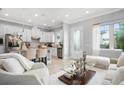 Open-concept living and kitchen area with large windows and modern finishes at 13437 Granger Ave, Orlando, FL 32827