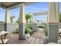 Covered patio area with tile flooring, seating, decor, and greenery at 13437 Granger Ave, Orlando, FL 32827