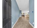 Inviting foyer with wood flooring, leading to the open-concept living spaces at 1397 Gatlin Pl, The Villages, FL 32163