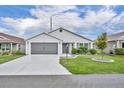 Charming single-story home with well-maintained landscaping and a two-car garage at 1397 Gatlin Pl, The Villages, FL 32163