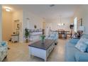 Bright living room featuring neutral tones, tile flooring, and comfortable seating arrangements at 1405 Osprey Ridge Dr, Eustis, FL 32736