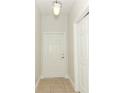 Bright entryway featuring tile flooring, a white front door, and a hanging light fixture at 1441 Twin Trees Ln, Sanford, FL 32771