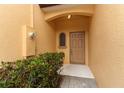 Close-up of a neutral-toned front door with covered entrance and adjacent window at 1441 Twin Trees Ln, Sanford, FL 32771