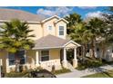 Two-story townhome with a charming covered porch and neatly landscaped surroundings at 17419 Placidity Ave, Clermont, FL 34714