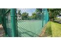 View of community tennis court surrounded by chain link fence at 200 Maitland Ave # 232, Altamonte Springs, FL 32701