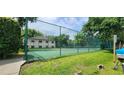 Community tennis court featuring a green surface, with lush landscaping at 200 Maitland Ave # 232, Altamonte Springs, FL 32701