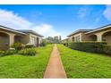 Exterior lawn view of charming home community with manicured lawns and inviting walkways at 206 Diamond Cv # 106, Casselberry, FL 32707