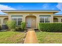 Quaint single-story home with a walkway, manicured hedges, and bright green lawn at 206 Diamond Cv # 106, Casselberry, FL 32707