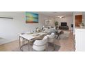 Open-concept living and dining area with modern furnishings and serene beach-themed artwork at 206 Diamond Cv # 106, Casselberry, FL 32707