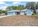 Charming single-story home featuring a well-maintained yard, palm tree, and an attached garage at 2106 Altoona Ln, Deltona, FL 32738
