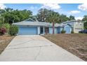 Charming single-story home featuring a well-maintained yard, palm tree, and an attached garage at 2106 Altoona Ln, Deltona, FL 32738
