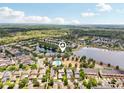Aerial view of a community featuring lakes, a pool, and neatly arranged homes with green spaces at 2116 Truffle Ln, Casselberry, FL 32707