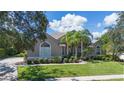 Attractive house with mature trees, manicured bushes, and a healthy green lawn at 2232 Lake Vilma Dr, Orlando, FL 32835